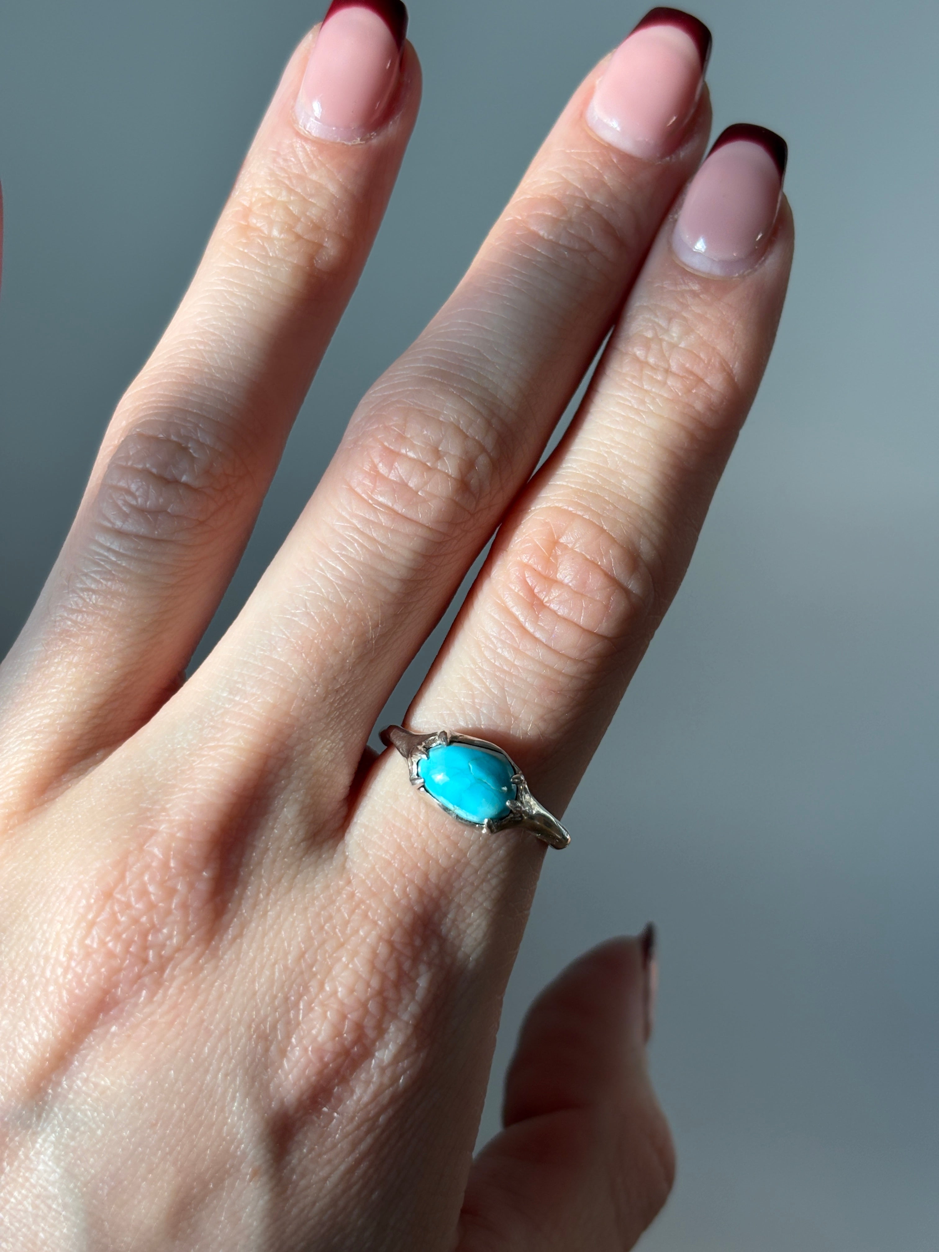 sterling silver and turquoise ring on a hand 