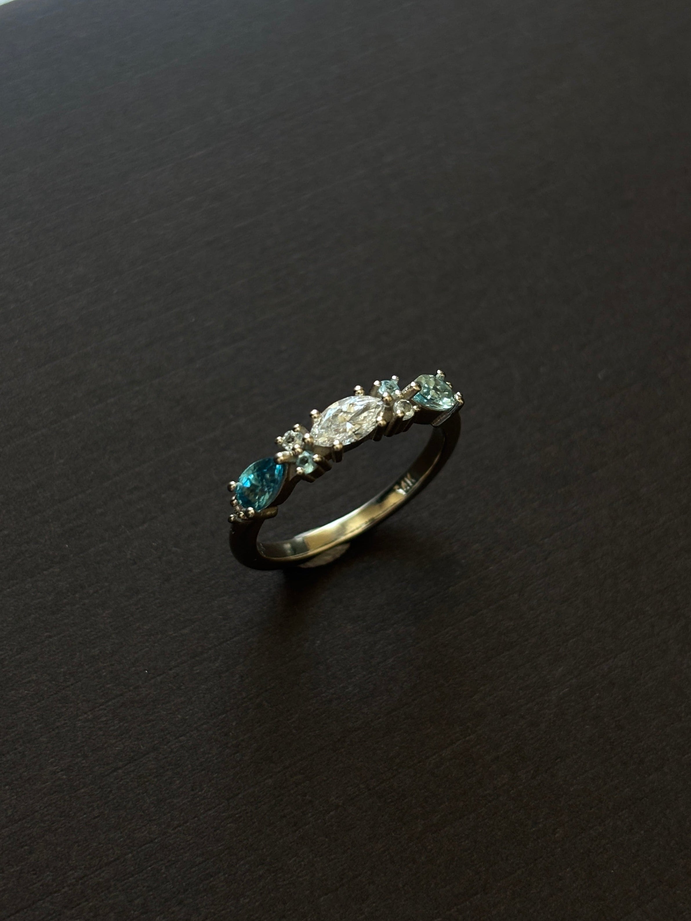Ring with gemstones on a dark textured surface