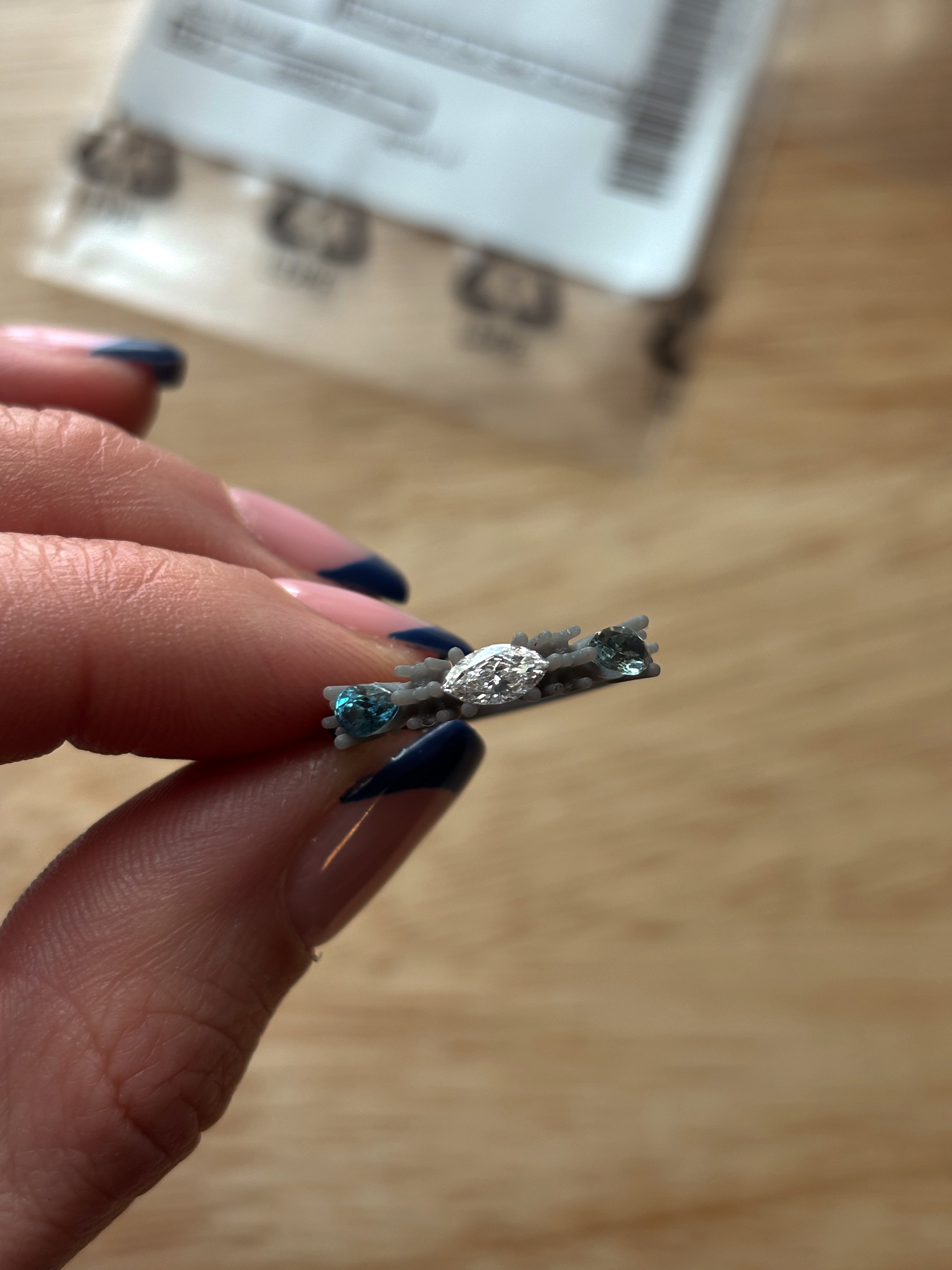 hand holding wax ring print with stones 3 stones set into the rig