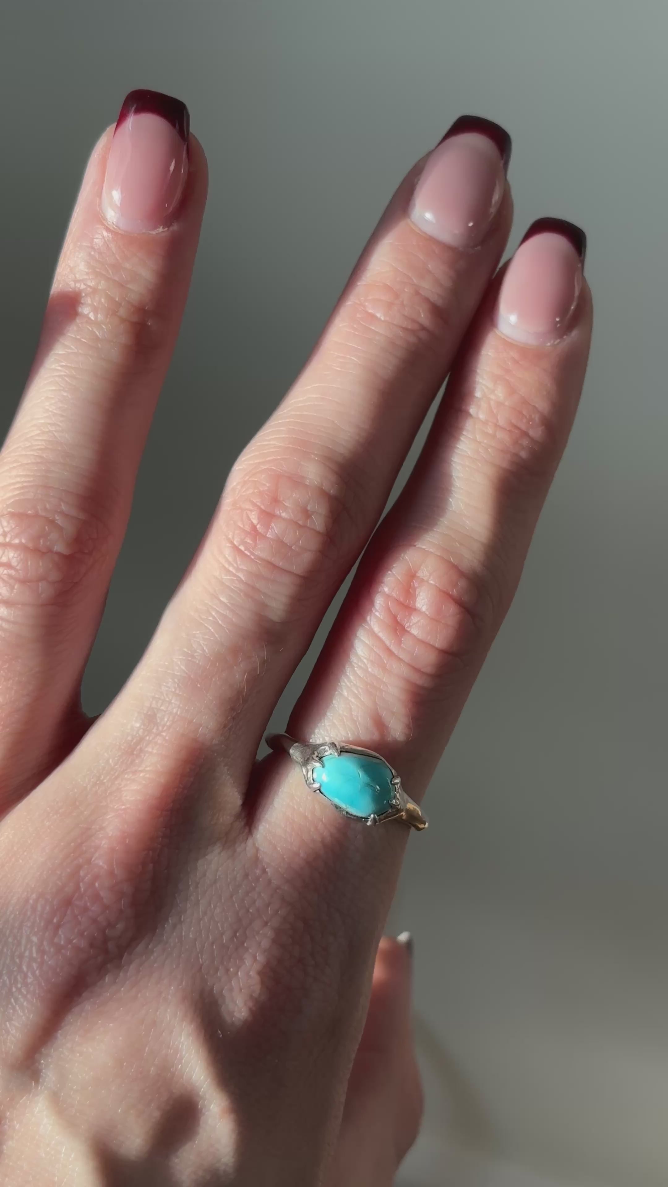 video of a turquoise and siler ring on a finger/hand
